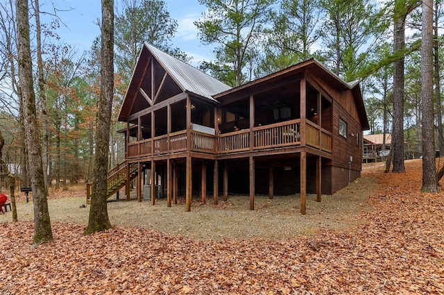 rear view of house featuring ceiling fan and a wooden deck