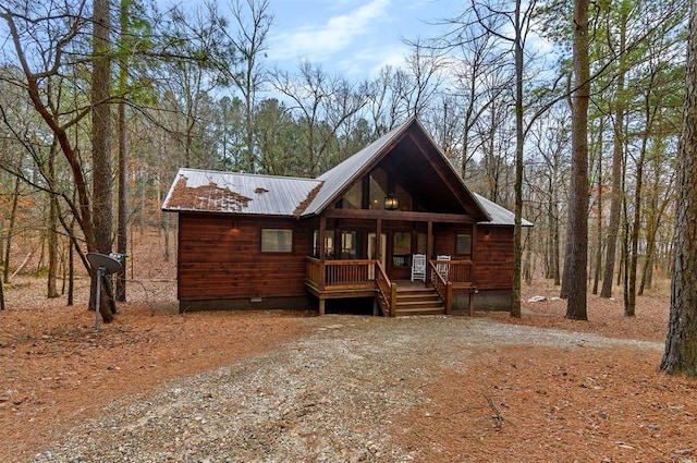 log-style house featuring covered porch