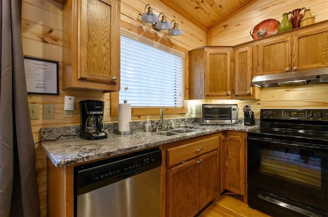 kitchen with sink, vaulted ceiling, stainless steel dishwasher, dark stone countertops, and black / electric stove