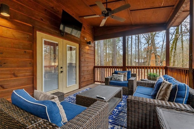 sunroom / solarium with ceiling fan and wooden ceiling