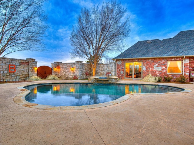 view of pool with an in ground hot tub and a patio area