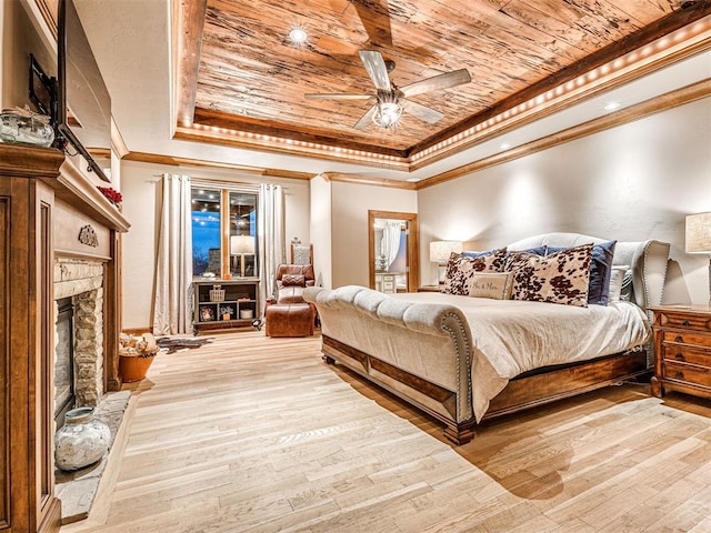 bedroom featuring wood-type flooring, a tray ceiling, ceiling fan, and wood ceiling