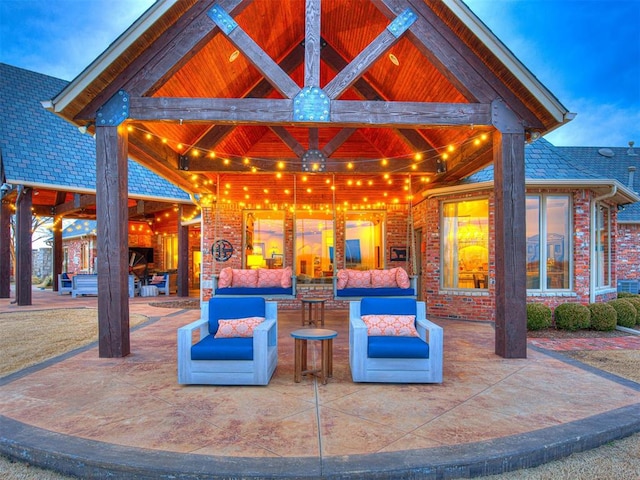 patio terrace at dusk featuring an outdoor living space