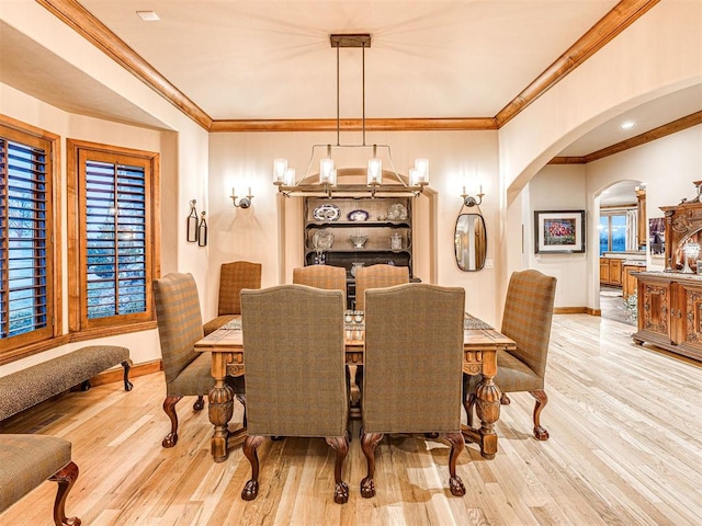 dining area featuring crown molding and light hardwood / wood-style flooring