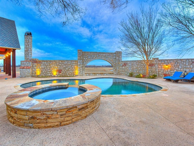 view of swimming pool with an in ground hot tub