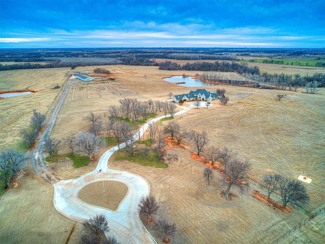 drone / aerial view featuring a water view and a rural view