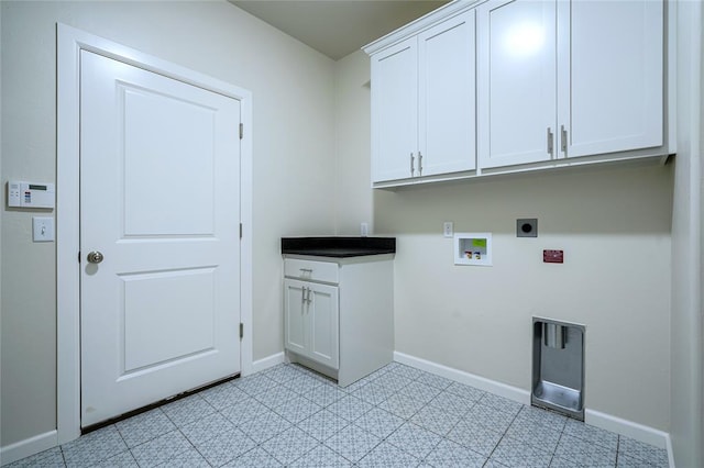 clothes washing area with hookup for an electric dryer, cabinets, and washer hookup