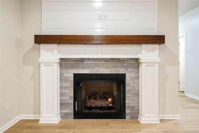 details with wood-type flooring and a brick fireplace