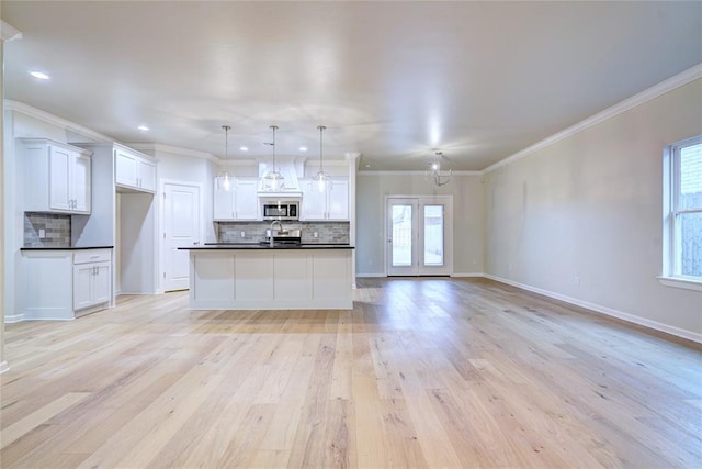 kitchen featuring white cabinetry, a wealth of natural light, and light hardwood / wood-style floors