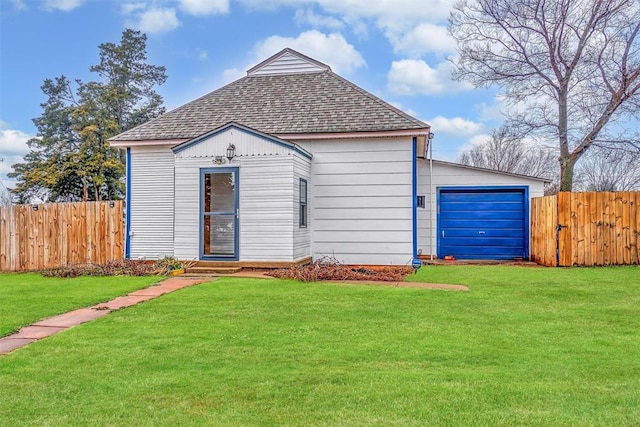 view of front of home featuring a garage and a front lawn