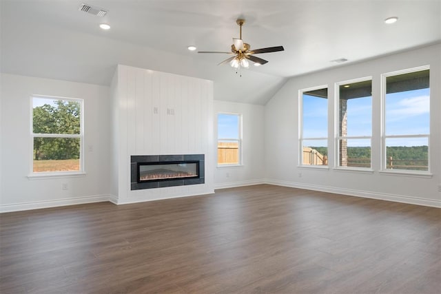 unfurnished living room featuring lofted ceiling, a large fireplace, ceiling fan, and dark hardwood / wood-style floors