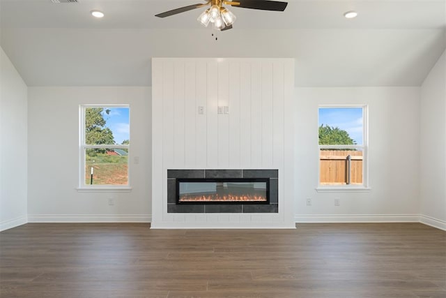 unfurnished living room with dark hardwood / wood-style floors, ceiling fan, and lofted ceiling