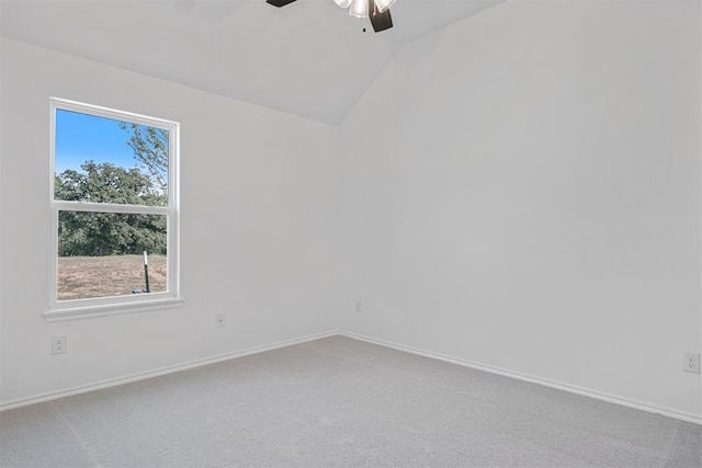 carpeted spare room featuring ceiling fan and lofted ceiling