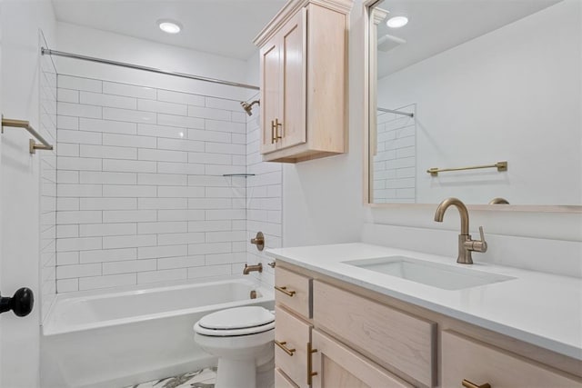 full bathroom featuring vanity, toilet, and tiled shower / bath combo