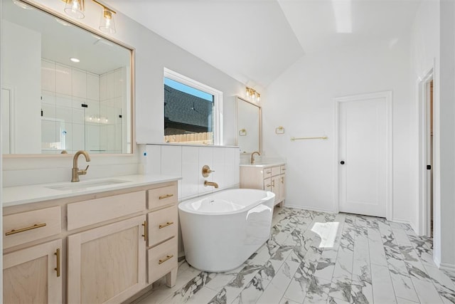 bathroom with vanity, independent shower and bath, and lofted ceiling