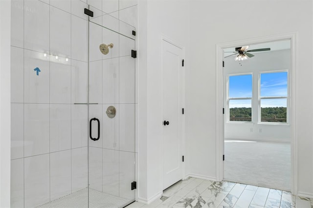 bathroom featuring walk in shower and ceiling fan