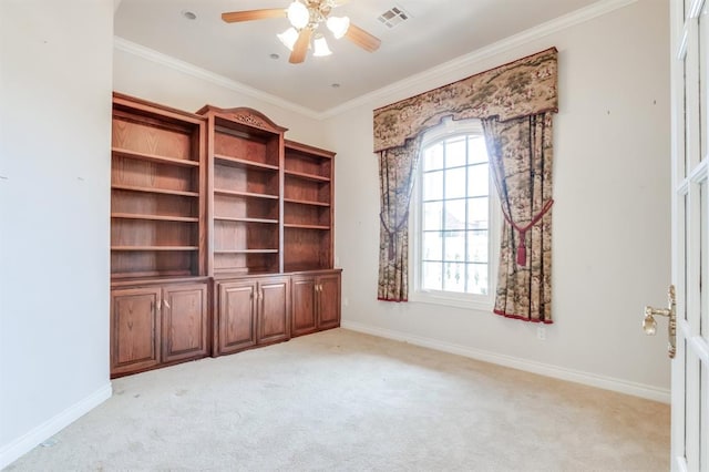 carpeted empty room with ceiling fan and crown molding