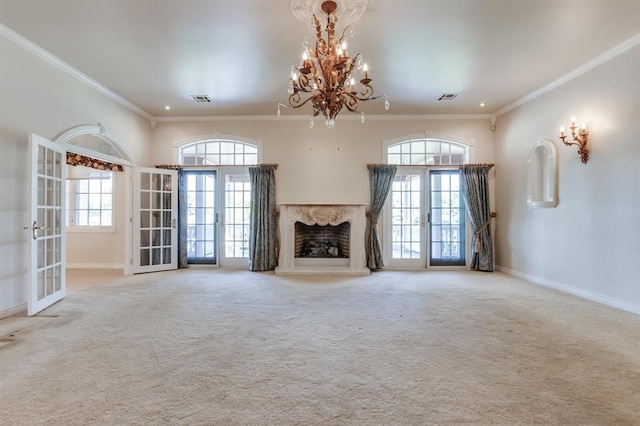 unfurnished living room featuring ornamental molding, a wealth of natural light, and french doors