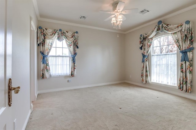 unfurnished room featuring light colored carpet, a wealth of natural light, crown molding, and ceiling fan