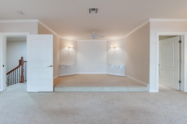 carpeted empty room with ceiling fan and ornamental molding