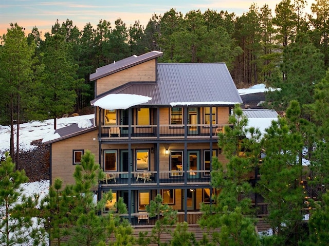 snow covered property featuring a balcony