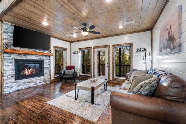 living room with ceiling fan, a fireplace, wood walls, hardwood / wood-style flooring, and wooden ceiling