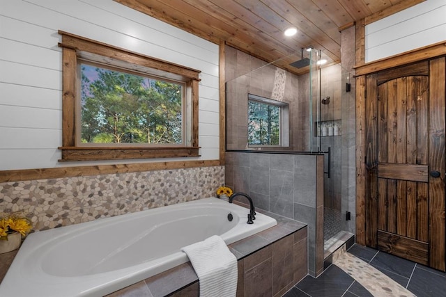 bathroom with independent shower and bath, tile patterned flooring, wood ceiling, and wooden walls