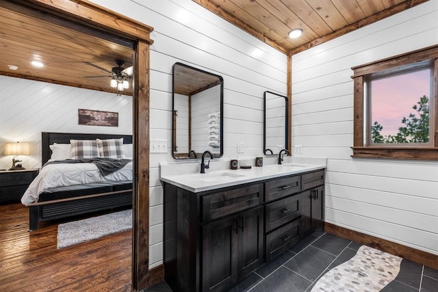 bathroom featuring vanity, wood ceiling, tile patterned floors, and wooden walls