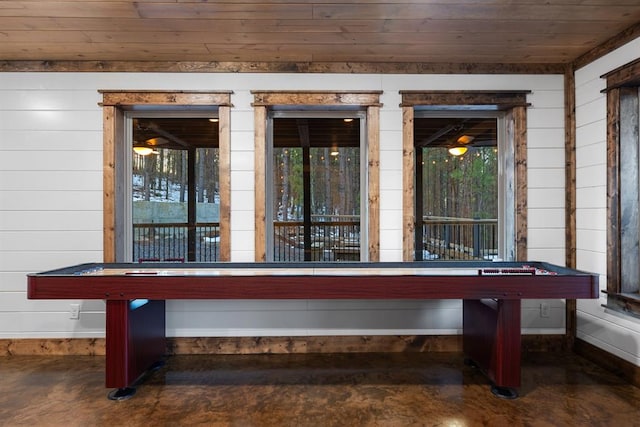 playroom featuring wood ceiling and wood walls