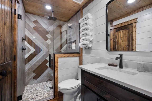 bathroom with wood ceiling, vanity, wooden walls, toilet, and walk in shower