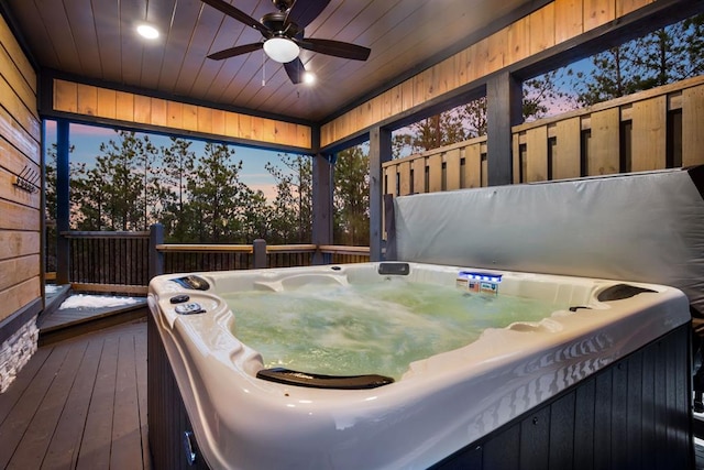 exterior space featuring ceiling fan, a jacuzzi, dark hardwood / wood-style floors, wooden walls, and wood ceiling