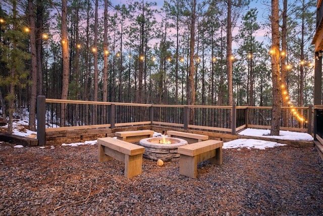 yard covered in snow featuring an outdoor fire pit