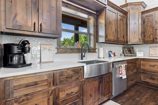 kitchen with backsplash, sink, and stainless steel dishwasher