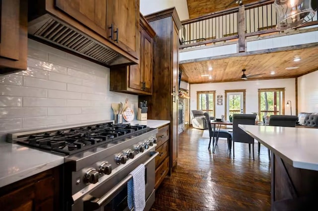 kitchen featuring ceiling fan, high end range, backsplash, and wooden ceiling