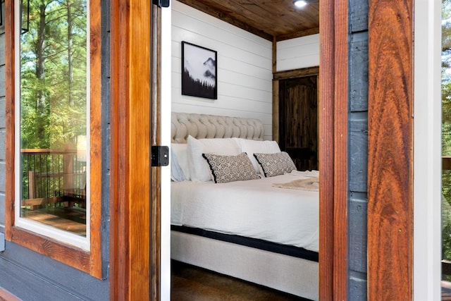 unfurnished bedroom featuring wooden walls and wooden ceiling