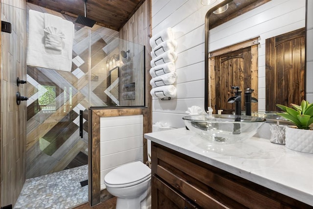 bathroom with vanity, wood walls, toilet, walk in shower, and wood ceiling