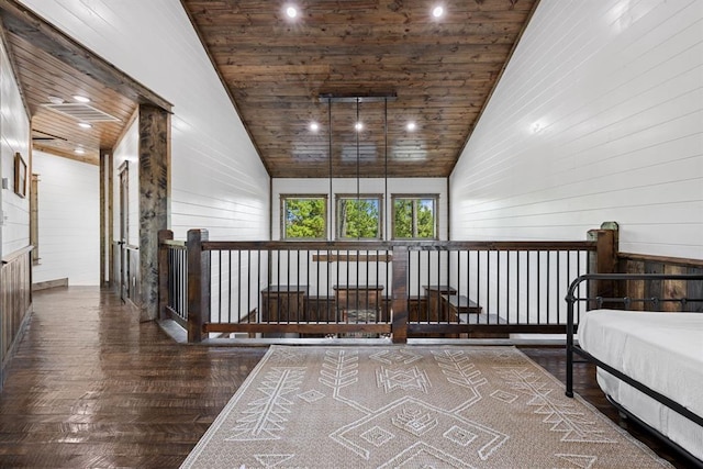 corridor featuring wooden walls, high vaulted ceiling, and wood ceiling