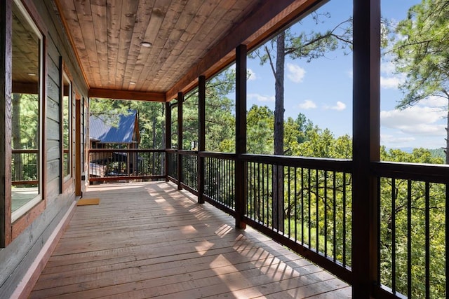 unfurnished sunroom featuring a wealth of natural light and wooden ceiling