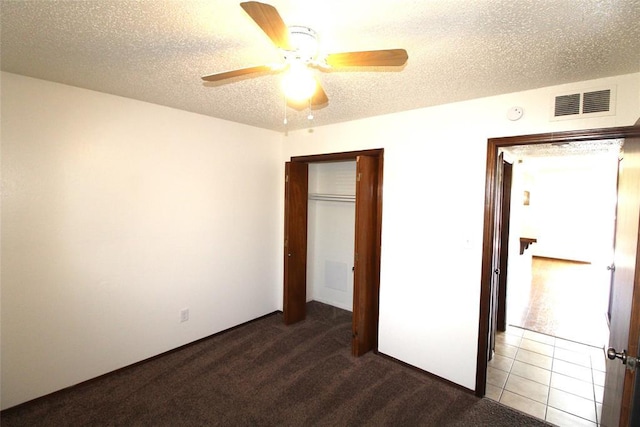 unfurnished bedroom featuring ceiling fan, carpet flooring, and a closet