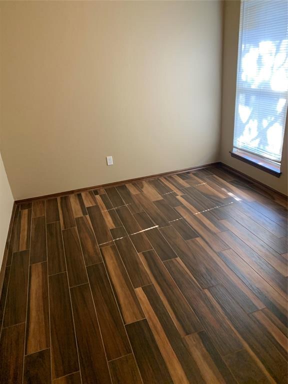 spare room with dark wood-type flooring