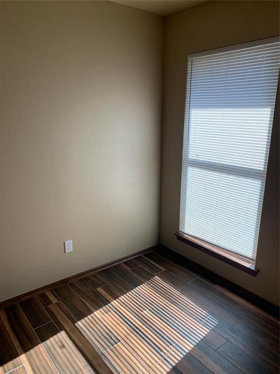 unfurnished room with dark hardwood / wood-style floors