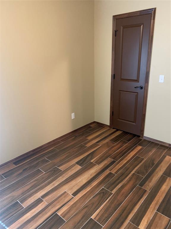 spare room featuring dark hardwood / wood-style flooring