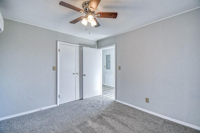 unfurnished bedroom with ceiling fan, light colored carpet, electric panel, and a closet