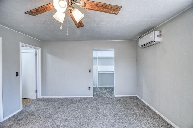 empty room with carpet, ceiling fan, a textured ceiling, and a wall unit AC