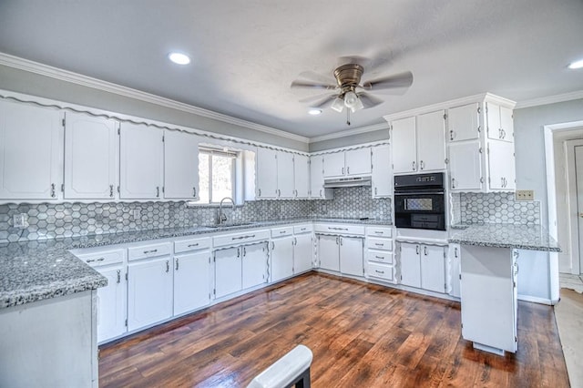 kitchen with black appliances, sink, white cabinets, and light stone counters