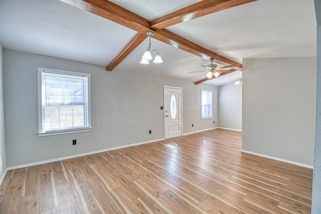 unfurnished living room featuring light hardwood / wood-style flooring, lofted ceiling with beams, and ceiling fan with notable chandelier