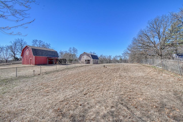 view of yard with a rural view and an outbuilding