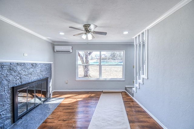 unfurnished living room with dark hardwood / wood-style floors, a wall mounted AC, ornamental molding, and ceiling fan