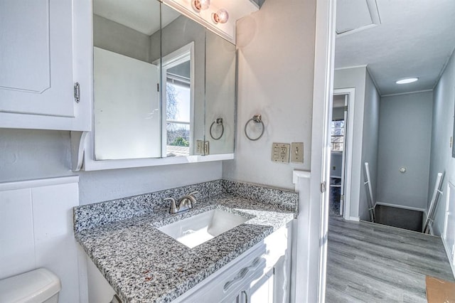 bathroom featuring hardwood / wood-style flooring, vanity, and toilet