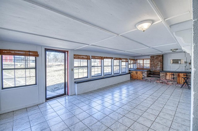 unfurnished sunroom featuring an AC wall unit